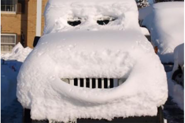 car covered in snow with a smiley face