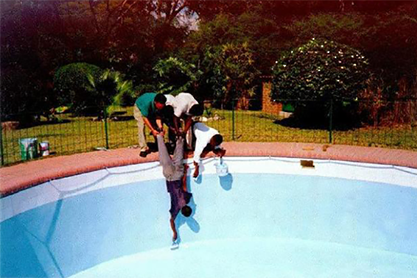 4 men painting a pool